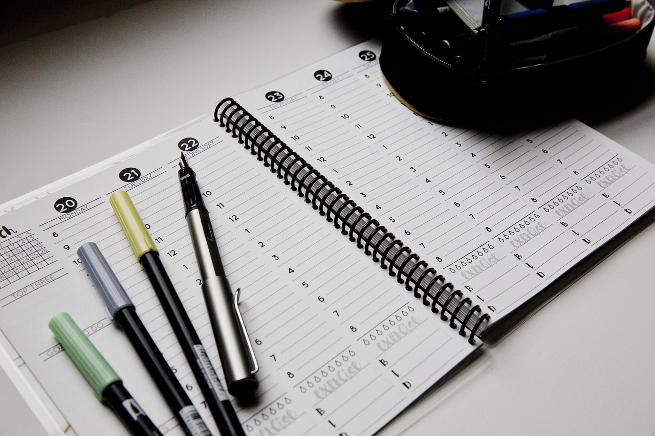 Doula reviewing weekly workflow planner