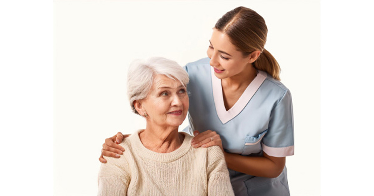 older woman sitting and looking up at a younger woman who is wearing a nursing uniform